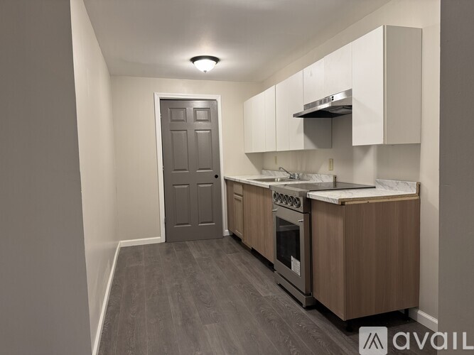 A kitchen with a stove top oven and a sink.