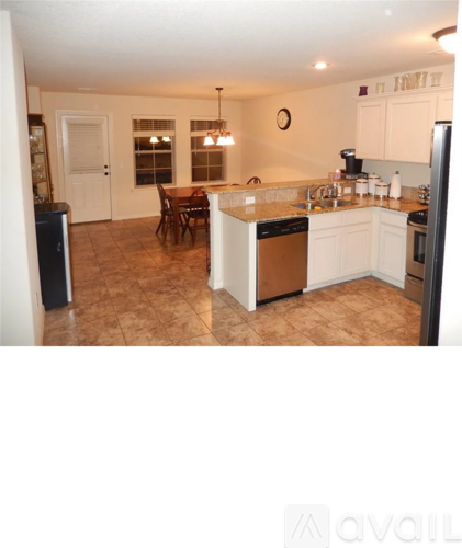 A kitchen with a table and chairs in the middle of the room.