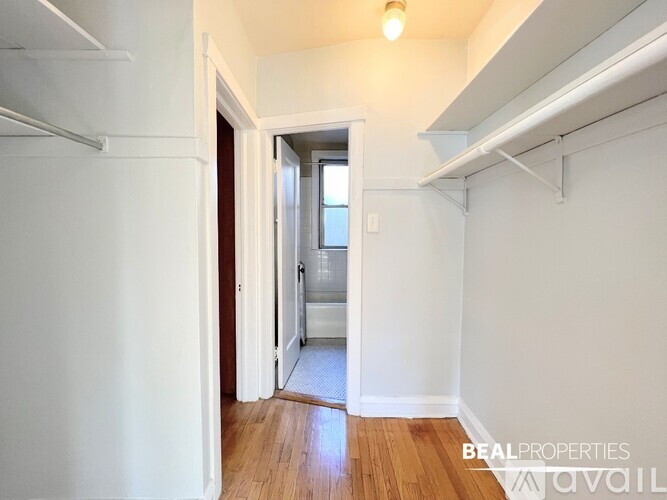 A hallway with a doorway leading to another room.
