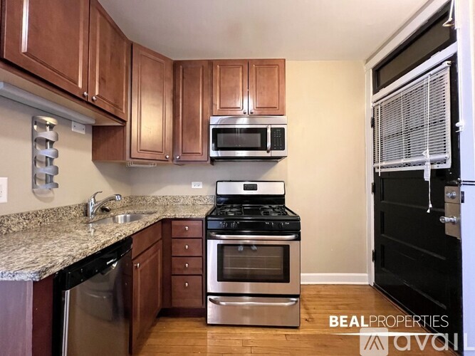 A kitchen with wooden cabinets and stainless steel appliances.