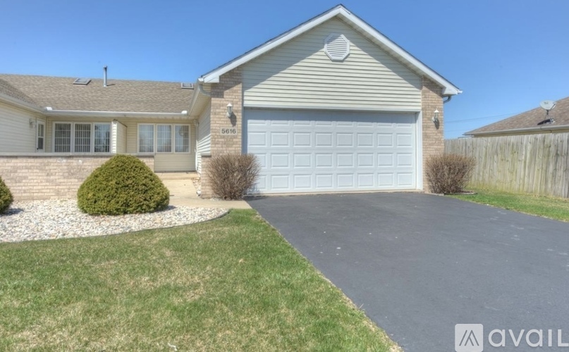 A house with a garage and a driveway.