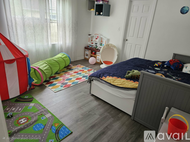 A child's bedroom with a bed, a play tent, and a play mat on the floor.