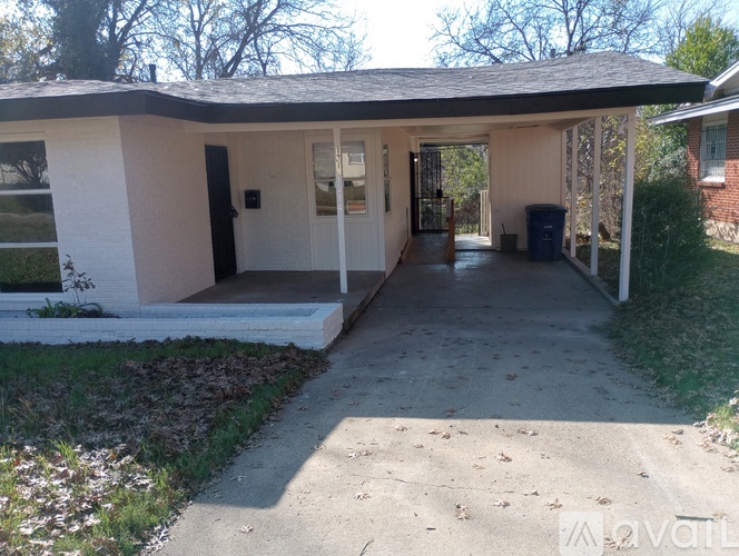 A small house with a porch and a trash can is for sale.