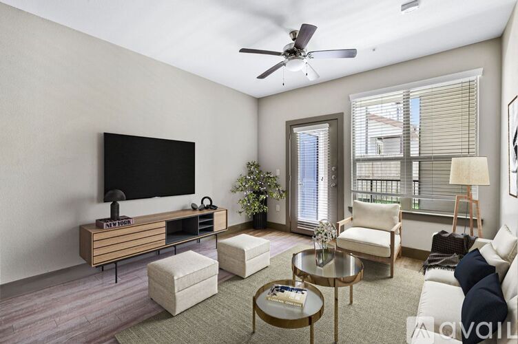 A living room with a flat screen TV and a glass coffee table.