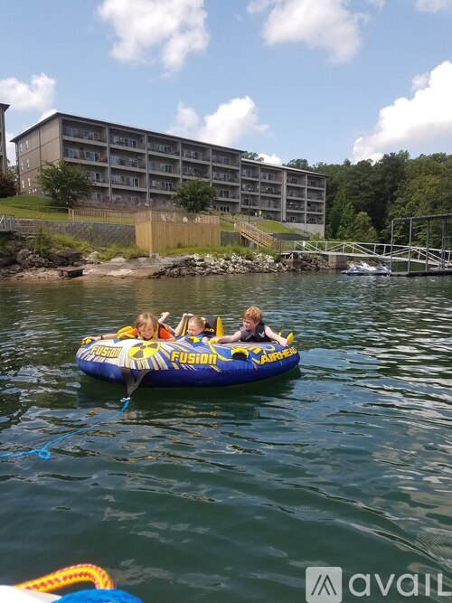 A group of people are riding on a blue and yellow raft with the word "FUSION" on it.