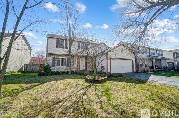 A house with a tree in the front yard.