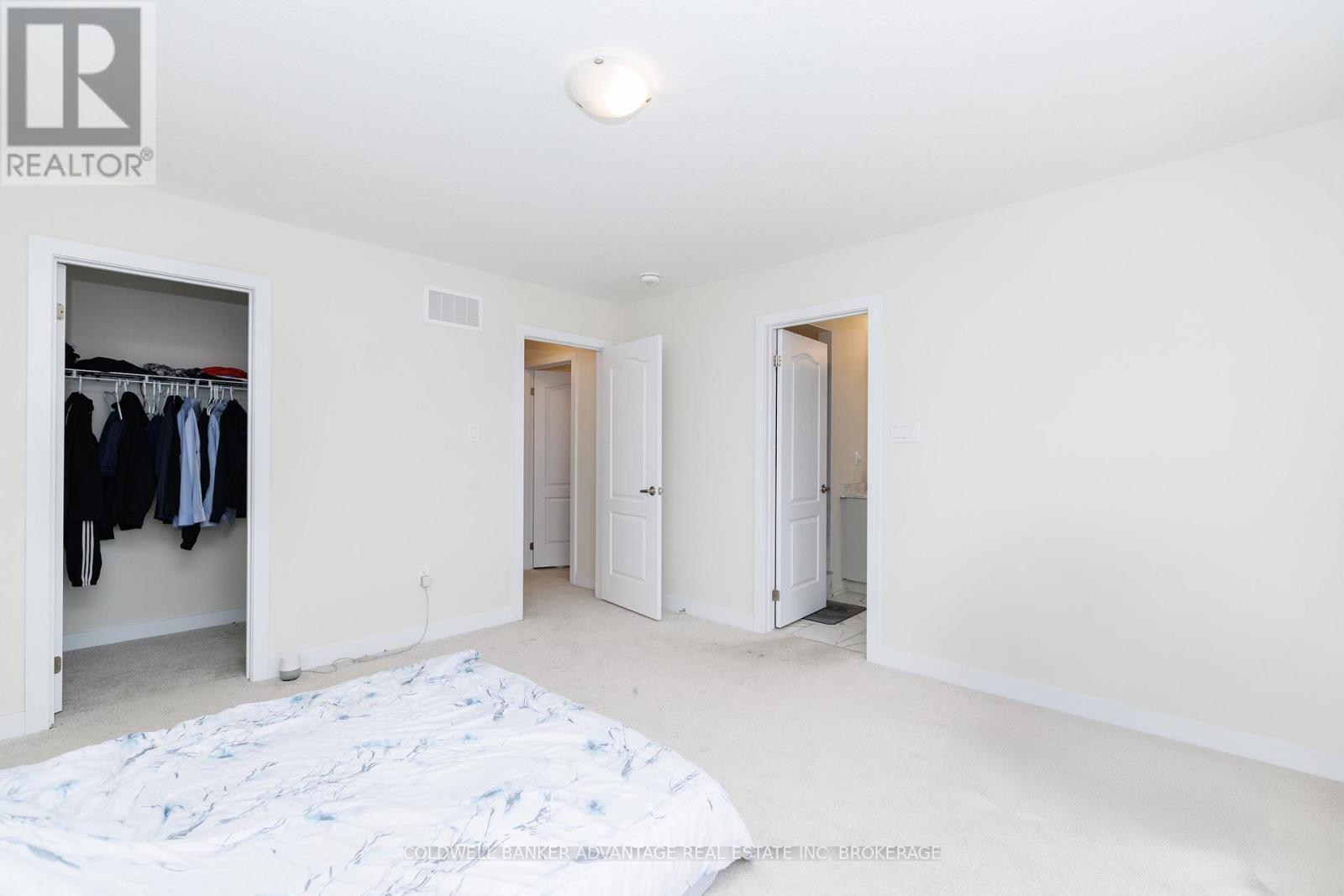 A bedroom with a bed and a wardrobe.