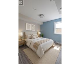 A bedroom with a large bed, two lamps, and two framed pictures on the wall.