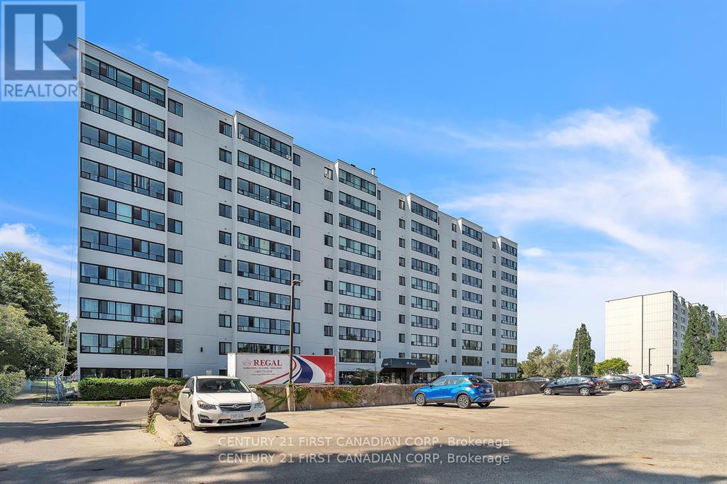 A large white building with a blue car parked in front of it.