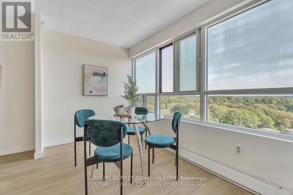 A dining room with a table and chairs.