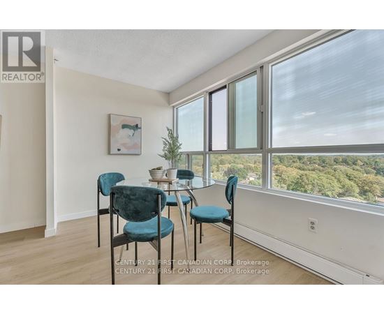 A dining room with a table and chairs.