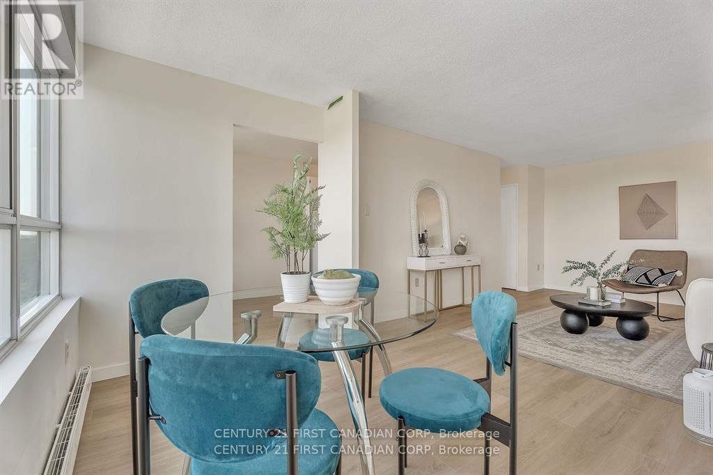 A living room with a glass table and blue chairs.