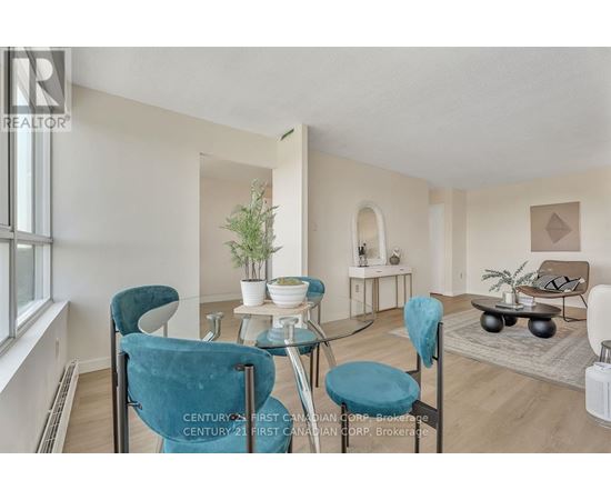 A living room with a glass table and blue chairs.