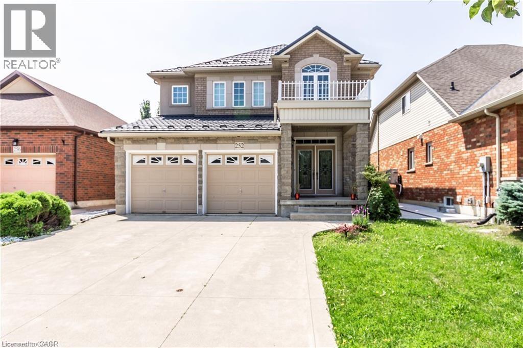 A two-story house with a garage is for sale.