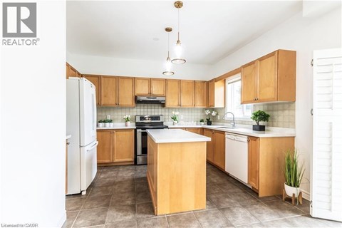 A kitchen with wooden cabinets and a white refrigerator.