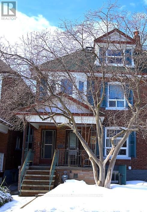 A house with a tree in front of it.