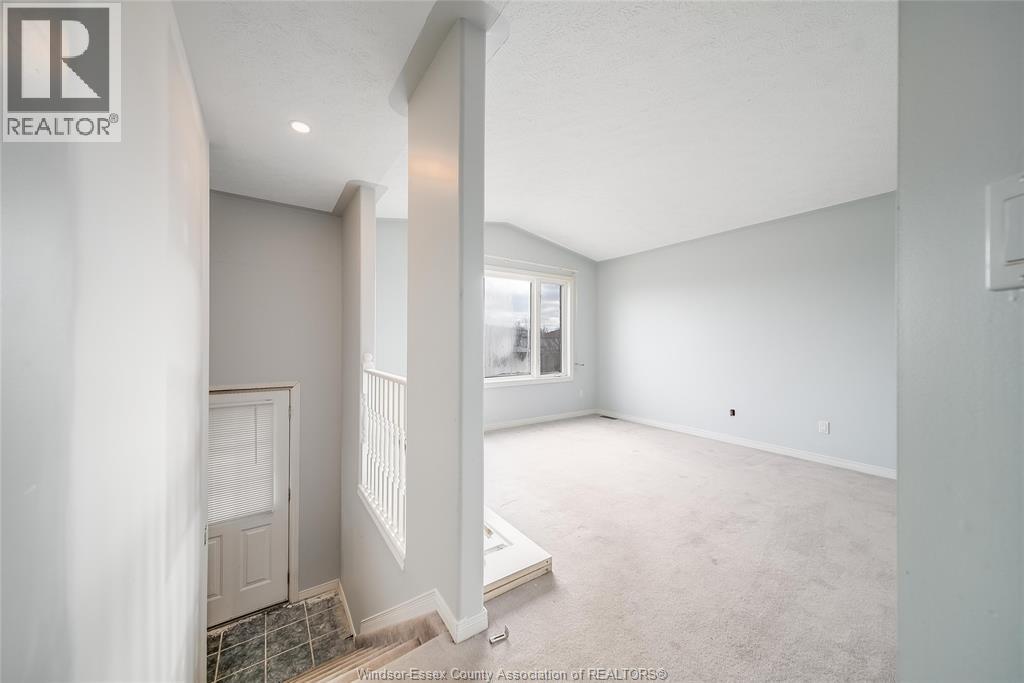 A spacious room with a door and a window.