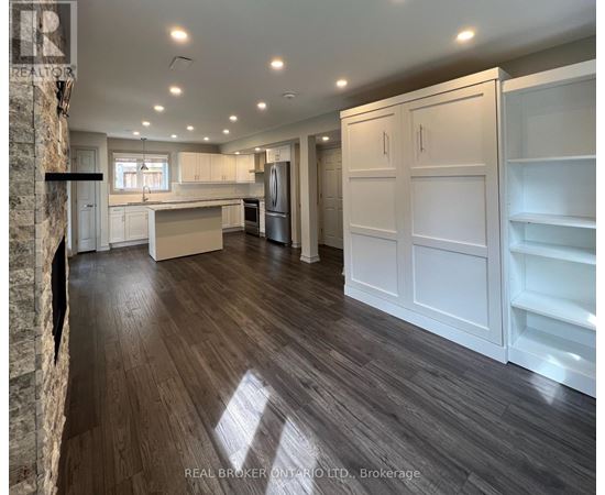 A bedroom with a bed, a fireplace, and a window.