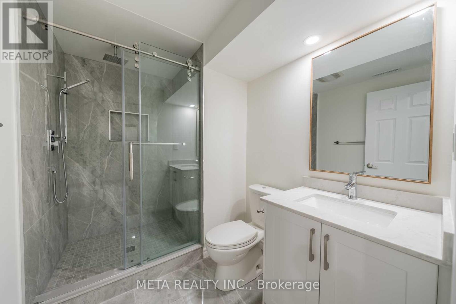 A bathroom with a walk-in shower and a toilet.