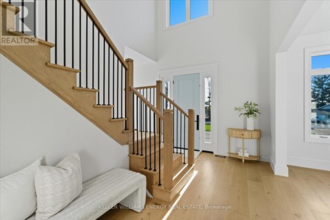 A living room with a couch and a staircase.