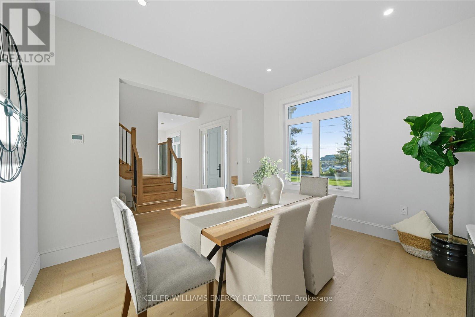 A dining room with a table and chairs.