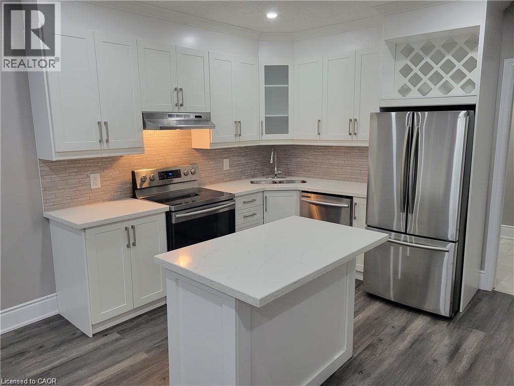 A kitchen with white cabinets and a large island.