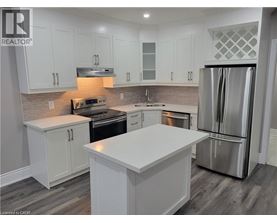 A kitchen with white cabinets and a large island.