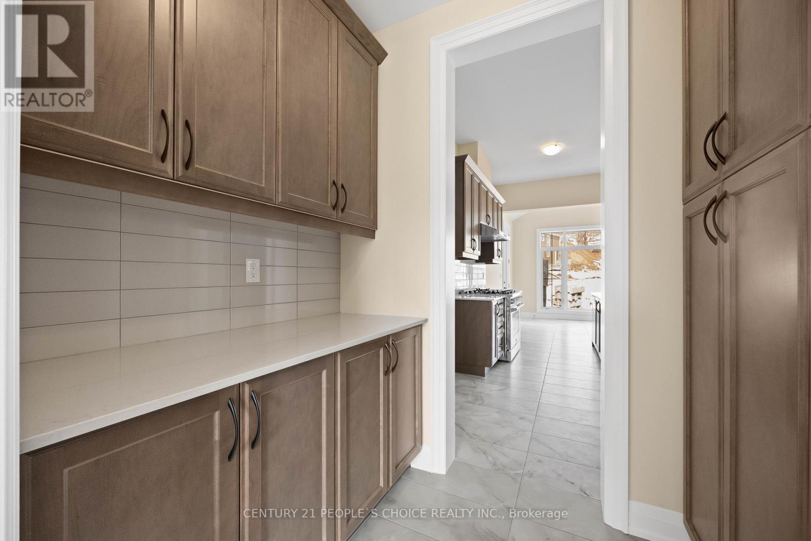 A kitchen with wooden cabinets and a white countertop.