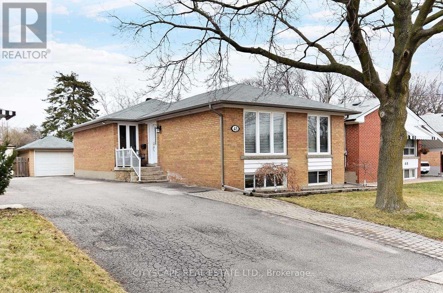 A house with a grey roof and a white door is for sale.