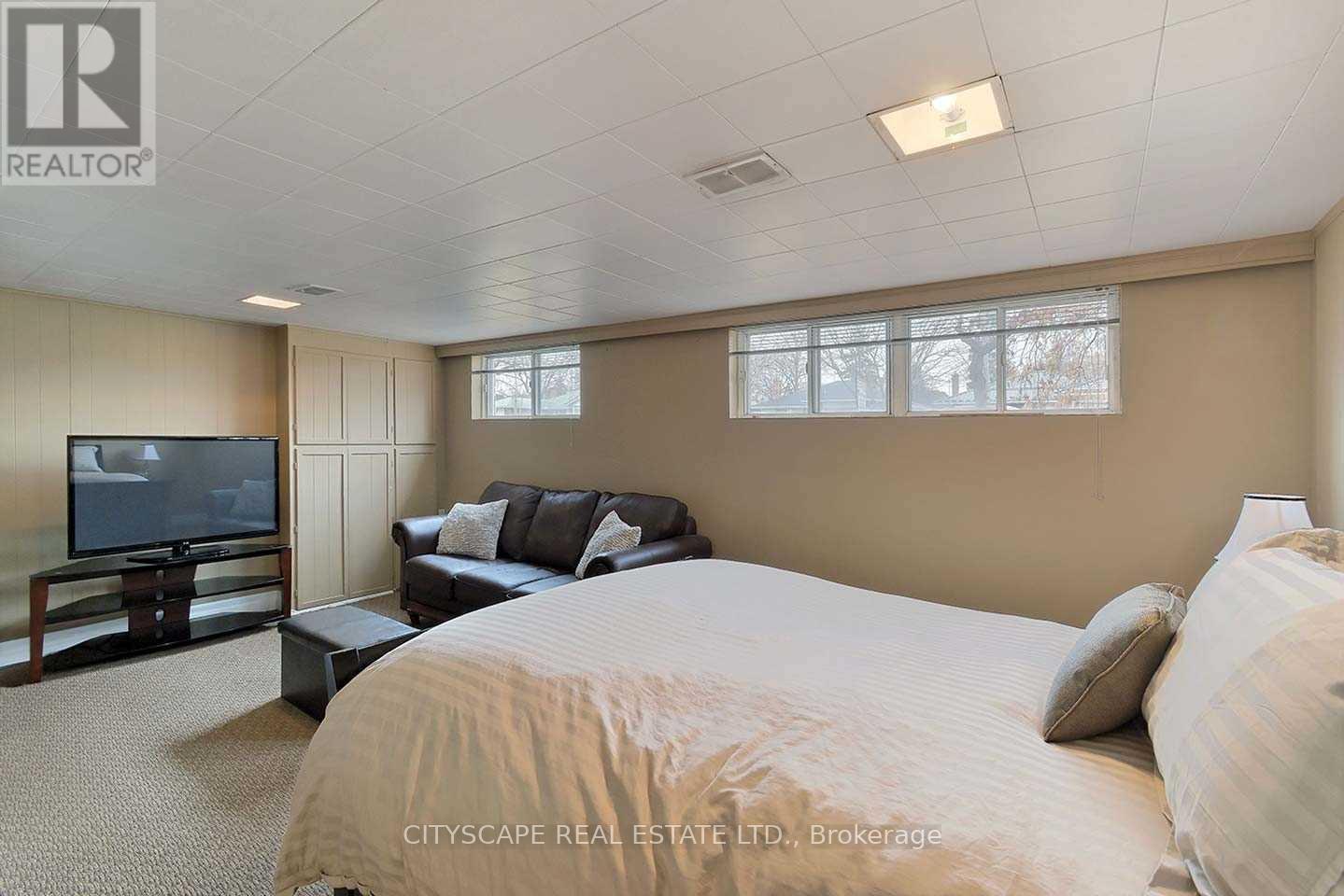 A bedroom with a large bed, a couch, and a television.