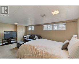 A bedroom with a large bed, a couch, and a television.