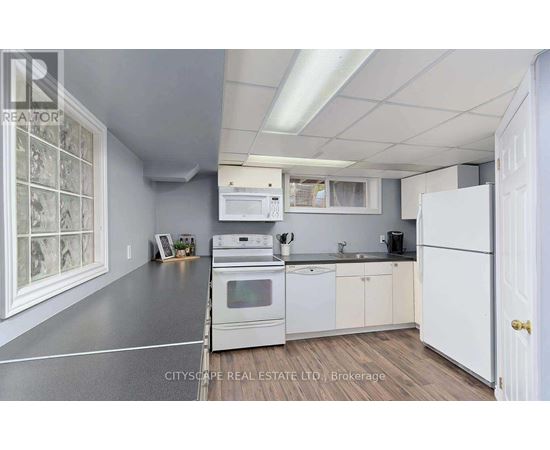 A kitchen with white appliances and cabinets is shown.