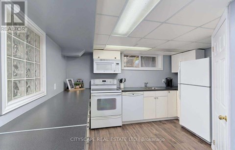 A kitchen with white appliances and cabinets is shown.