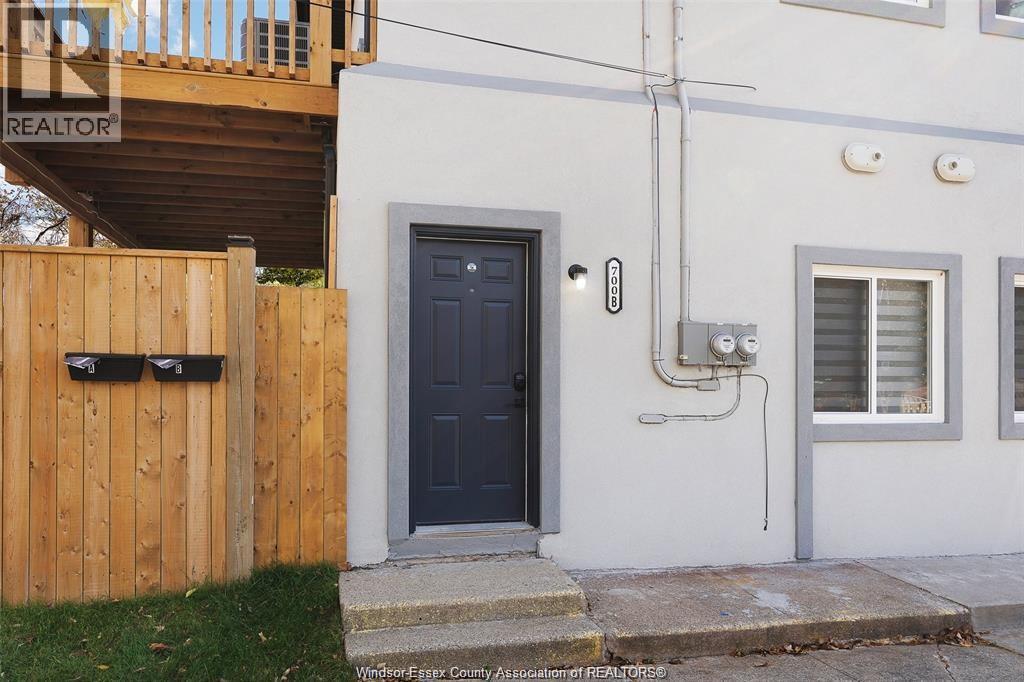 A house with a black door and a wooden fence.