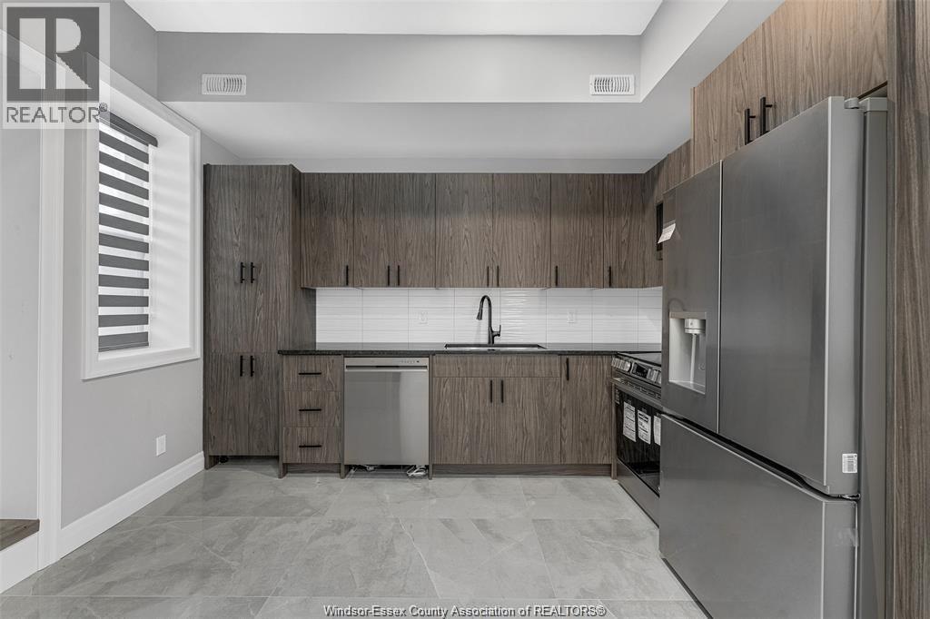 A kitchen with wooden cabinets and stainless steel appliances.