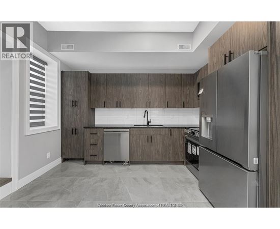 A kitchen with wooden cabinets and stainless steel appliances.
