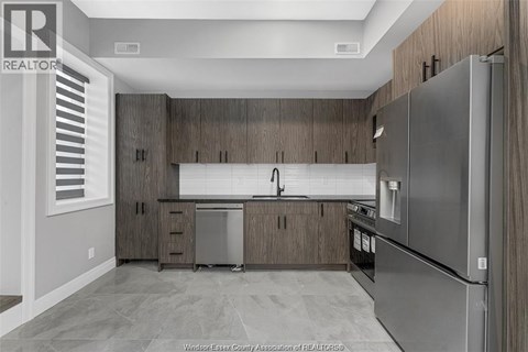 A kitchen with wooden cabinets and stainless steel appliances.