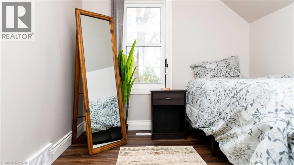 A bedroom with a bed, a dresser, and a mirror.