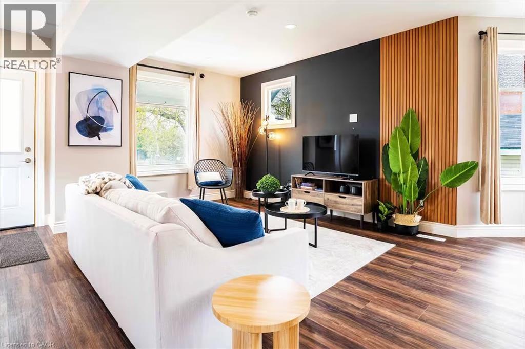 A living room with a white couch and a wooden table.