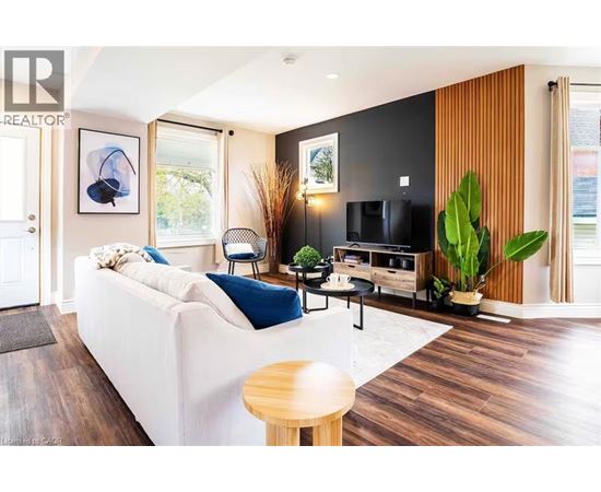 A living room with a white couch and a wooden table.