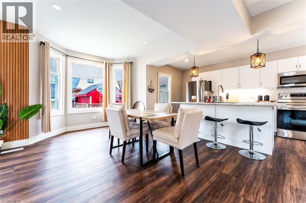A modern kitchen with a dining table and chairs.
