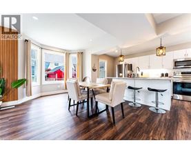 A modern kitchen with a dining table and chairs.