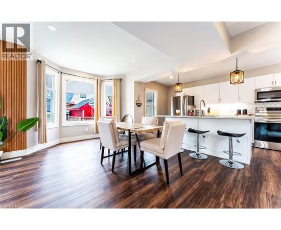 A modern kitchen with a dining table and chairs.