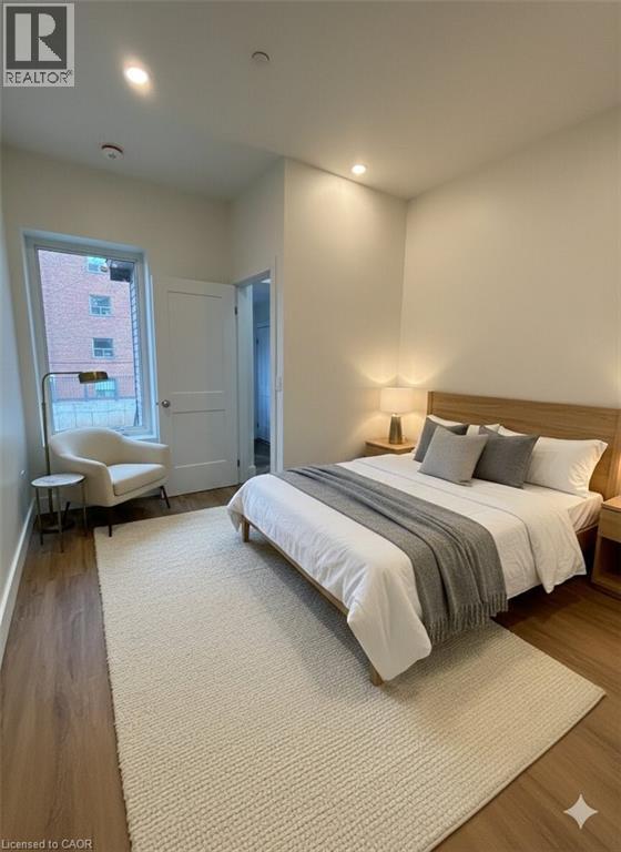 A bedroom with a large bed and a chair by the window.