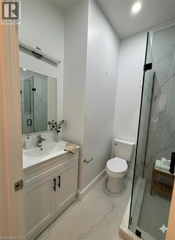 A bathroom with a sink, toilet, and shower.