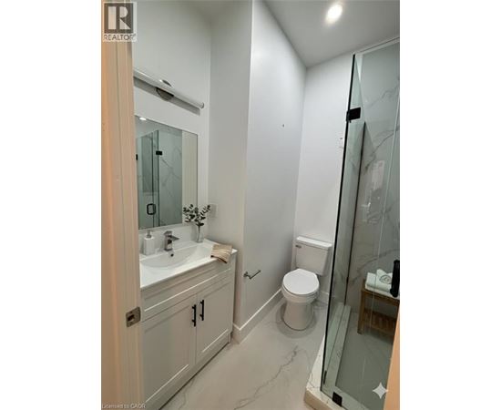 A bathroom with a sink, toilet, and shower.