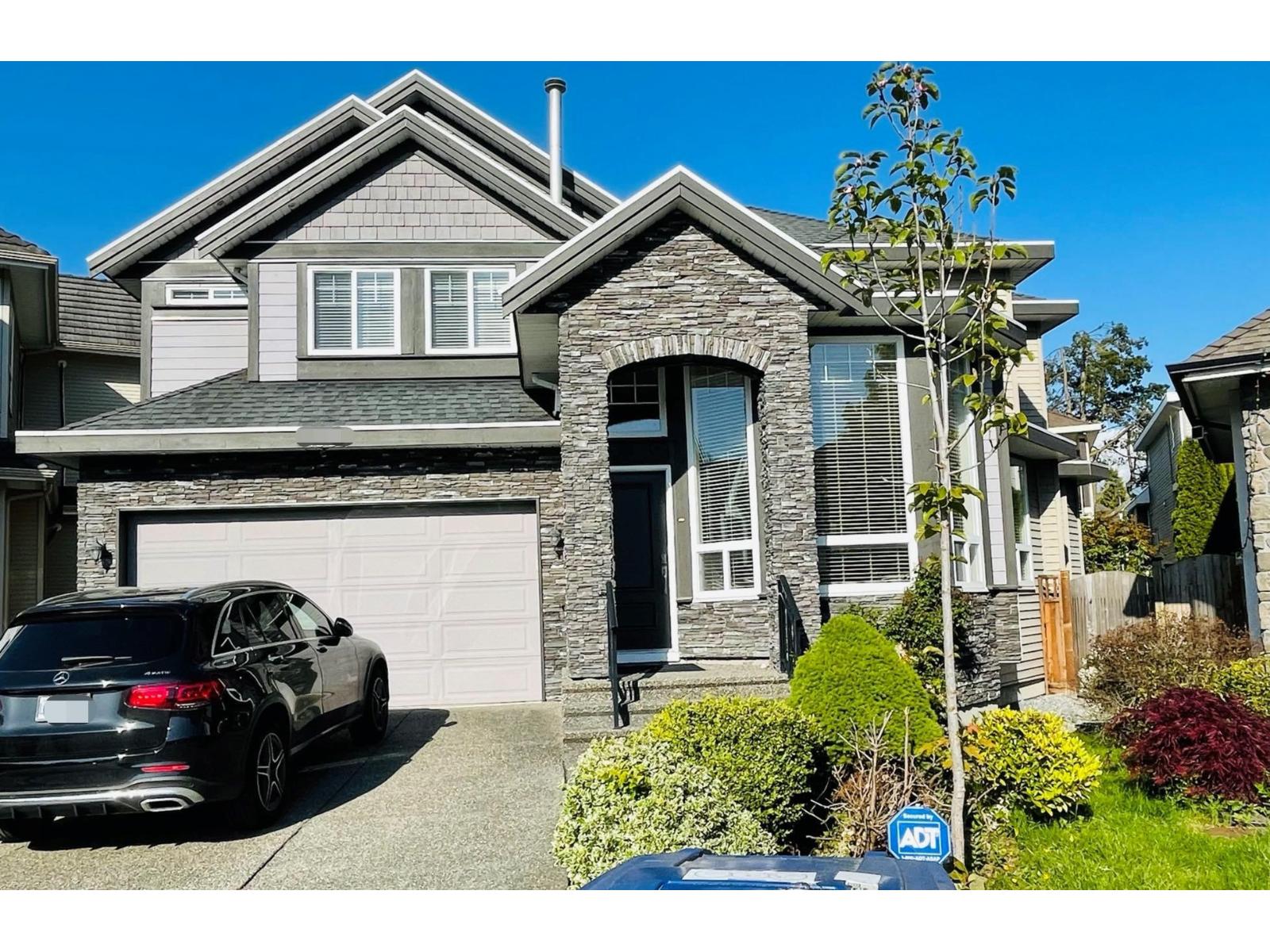 A house with a car parked in front of it.