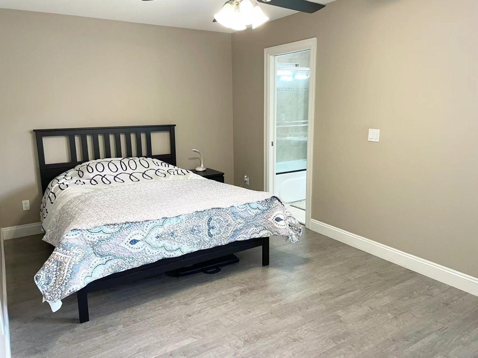 A bedroom with a bed and a door.