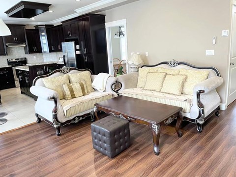 A living room with a white sofa and a coffee table.