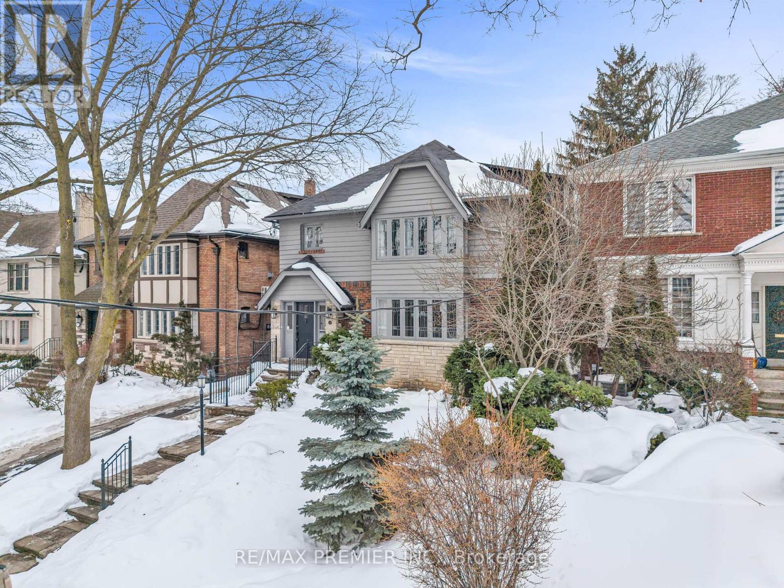 A house with a snow-covered front yard.